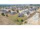 Aerial view shows a large backyard with an enclosed porch and solar panels at 3560 Spring Creek Rd, Dundee, FL 33838