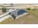 Aerial view showcases solar panels, well-maintained landscaping, and an inviting home exterior at 3560 Spring Creek Rd, Dundee, FL 33838