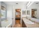 Bright bathroom featuring a tub, a double sink vanity, and an open doorway to the bedroom at 3560 Spring Creek Rd, Dundee, FL 33838