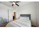 Bedroom featuring a striped bedspread, ceiling fan and view to the next room at 3560 Spring Creek Rd, Dundee, FL 33838