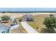 Charming single-story home featuring a stone facade, well-manicured lawn, and a paved driveway leading to an attached garage at 3560 Spring Creek Rd, Dundee, FL 33838