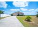 Well-maintained single-Gathering home with stone accents, a two-car garage, and a nicely landscaped front yard with a palm tree at 3560 Spring Creek Rd, Dundee, FL 33838