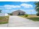 Beautiful home featuring a stone facade, a well-kept lawn, and a concrete driveway leading to an attached two-car garage at 3560 Spring Creek Rd, Dundee, FL 33838