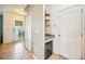 Well-lit hallway featuring storage space, tiled flooring, and decorative door with glass detail at 3560 Spring Creek Rd, Dundee, FL 33838
