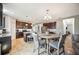 Well-appointed kitchen with dark cabinets, an island with seating, and an adjacent dining area at 3560 Spring Creek Rd, Dundee, FL 33838