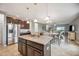 Spacious kitchen with a large island, granite countertops, and dark wood cabinets offers ample space at 3560 Spring Creek Rd, Dundee, FL 33838