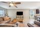 Inviting living room with a ceiling fan, TV, and comfortable seating offers a relaxing atmosphere at 3560 Spring Creek Rd, Dundee, FL 33838