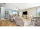 The living room with a ceiling fan, comfortable seating, and natural light invites relaxation and enjoyment at 3560 Spring Creek Rd, Dundee, FL 33838