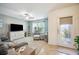Inviting living room with a ceiling fan, plush seating, and decorative shelving with view of front door at 3560 Spring Creek Rd, Dundee, FL 33838