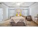 The primary bedroom offers a tray ceiling, carpeting, and neutral tones to create a soothing retreat at 3560 Spring Creek Rd, Dundee, FL 33838
