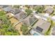 This aerial view highlights the home's grassy backyard, mature tree coverage, and fenced-in yard at 3592 Prescott Loop, Lakeland, FL 33810