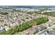 This aerial shot shows a residential neighborhood with lush tree coverage and well maintained streets at 3592 Prescott Loop, Lakeland, FL 33810
