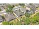 This aerial view highlights the home's grassy backyard, mature tree coverage, and fenced-in yard at 3592 Prescott Loop, Lakeland, FL 33810