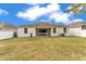 A fenced backyard boasts ample green space and an inviting covered patio at 3592 Prescott Loop, Lakeland, FL 33810