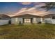 A fenced backyard boasts ample green space and an inviting covered patio at 3592 Prescott Loop, Lakeland, FL 33810
