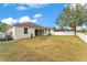 Large backyard features ample space, a covered patio, and white fence at 3592 Prescott Loop, Lakeland, FL 33810