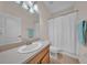 Cozy bathroom featuring a single vanity, tile floors, and a shower with a curtain at 3592 Prescott Loop, Lakeland, FL 33810