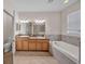 Bright bathroom with double vanity, soaking tub and tile flooring provides a spa-like experience at 3592 Prescott Loop, Lakeland, FL 33810
