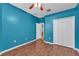 Bright bedroom features a ceiling fan, wood floors, and ample closet space at 3592 Prescott Loop, Lakeland, FL 33810