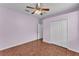 Bright bedroom showcases wood floors, a ceiling fan, a window, and a closet at 3592 Prescott Loop, Lakeland, FL 33810