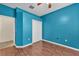 Stylish bedroom showcases wood floors, a ceiling fan, a closet, and an open doorway at 3592 Prescott Loop, Lakeland, FL 33810