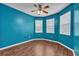 Vibrant bedroom featuring wood floors, a ceiling fan, and three windows for ample sunlight at 3592 Prescott Loop, Lakeland, FL 33810