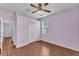 Cheerful bedroom features beautiful wood floors, a ceiling fan, a window, and closet at 3592 Prescott Loop, Lakeland, FL 33810