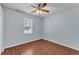 Cozy bedroom showcasing beautiful wood floors, a ceiling fan, and a window with natural light at 3592 Prescott Loop, Lakeland, FL 33810
