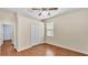 Bedroom with wood-look floors, ceiling fan, and closet with a window at 3592 Prescott Loop, Lakeland, FL 33810