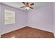 Inviting bedroom displaying wood floors, a ceiling fan, and a window with natural lighting at 3592 Prescott Loop, Lakeland, FL 33810