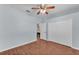 Charming bedroom features wood floors, a ceiling fan, and a spacious closet with white doors at 3592 Prescott Loop, Lakeland, FL 33810