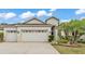 Charming home with a three car garage, well maintained lawn, and tropical landscaping at 3592 Prescott Loop, Lakeland, FL 33810