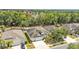 Charming single Gathering home with a two car garage and driveway surrounded by mature trees and landscaping at 3592 Prescott Loop, Lakeland, FL 33810