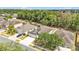 This aerial view highlights the home's lush tree coverage, two car garage and welcoming front yard at 3592 Prescott Loop, Lakeland, FL 33810
