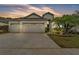 Charming home with a three-car garage, well-manicured landscaping, and lovely curb appeal at 3592 Prescott Loop, Lakeland, FL 33810