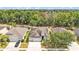 This aerial view highlights the home's mature trees, two car garage and welcoming front yard at 3592 Prescott Loop, Lakeland, FL 33810