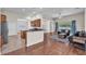 Open layout with hardwood flooring seamlessly connecting the kitchen and living room areas at 3592 Prescott Loop, Lakeland, FL 33810