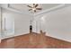 Spacious main bedroom boasts a ceiling fan, hardwood floors, and access to bathroom at 3592 Prescott Loop, Lakeland, FL 33810
