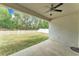 Covered patio overlooks a large backyard with a white picket fence at 3592 Prescott Loop, Lakeland, FL 33810