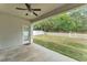 Covered patio overlooking a spacious backyard with a white picket fence at 3592 Prescott Loop, Lakeland, FL 33810