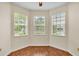 Bay window room features three windows with shades and wood-look flooring at 3592 Prescott Loop, Lakeland, FL 33810