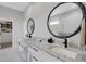 Modern main bathroom featuring double sinks, granite countertops, and a large walk-in closet at 3664 Frentress Dr, Lakeland, FL 33812