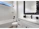 Modern white bathroom with granite countertops, black fixtures, and a bathtub at 3664 Frentress Dr, Lakeland, FL 33812
