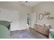 Bedroom featuring a crib and dresser with a changing pad, adjacent to the doorway at 3664 Frentress Dr, Lakeland, FL 33812