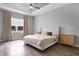 Spacious main bedroom featuring tray ceilings, wood-look floors, and large windows for ample natural light at 3664 Frentress Dr, Lakeland, FL 33812