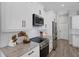 Modern kitchen features stainless steel appliances, white shaker cabinets, and granite countertops at 3664 Frentress Dr, Lakeland, FL 33812