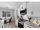 Bright kitchen and dining area with stainless steel appliances, white cabinets, and an elegant pendant light at 3664 Frentress Dr, Lakeland, FL 33812