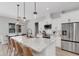 Modern kitchen with island, white cabinets, granite countertops and seating at 3664 Frentress Dr, Lakeland, FL 33812