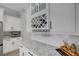 Bright, modern kitchen featuring a built-in wine rack, granite countertops, and stainless steel appliances at 3664 Frentress Dr, Lakeland, FL 33812