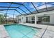 A refreshing pool is surrounded by a screened enclosure and ample patio space for lounging at 3664 Frentress Dr, Lakeland, FL 33812